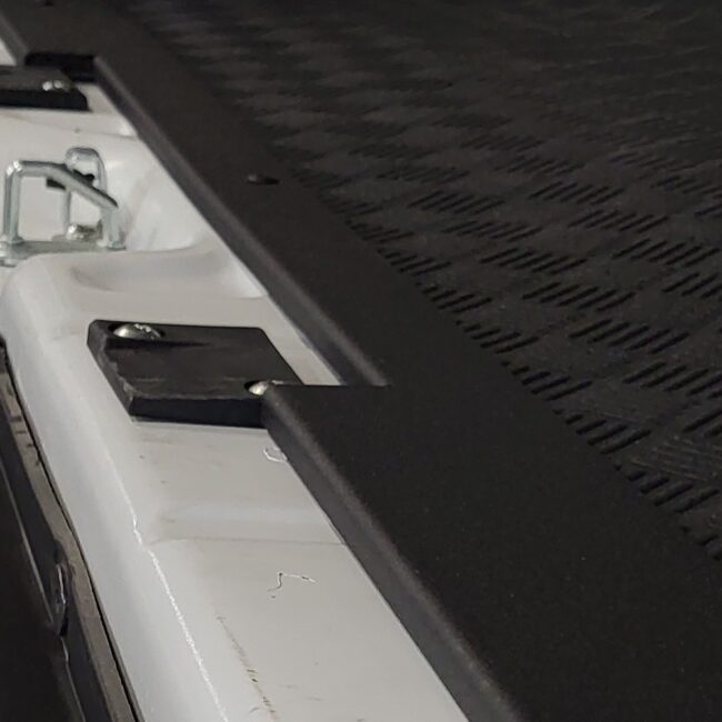 RAM ProMAster black textured sill installed in the van rear.