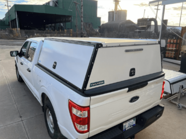 Rear view of an Adrian Steel aluminum topper mounted on a truck.