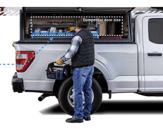 Aluminum topper installed on truck bed with side access door open.